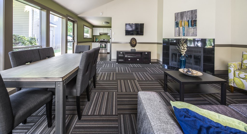 a living room with a table and chairs and a television