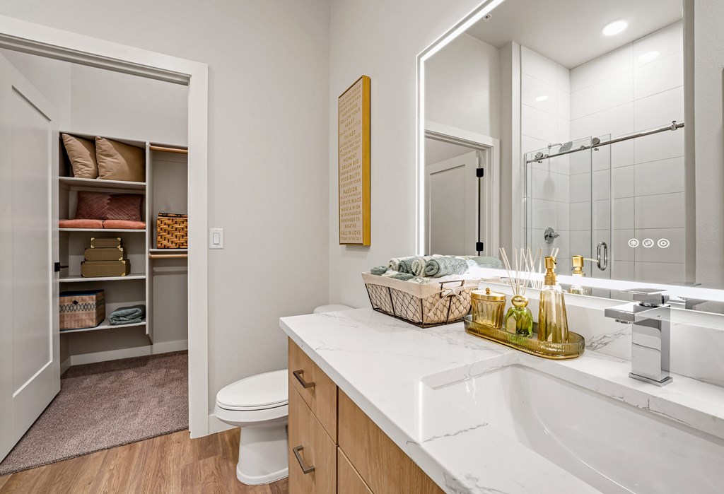 A bathroom with a white sink and a toilet.