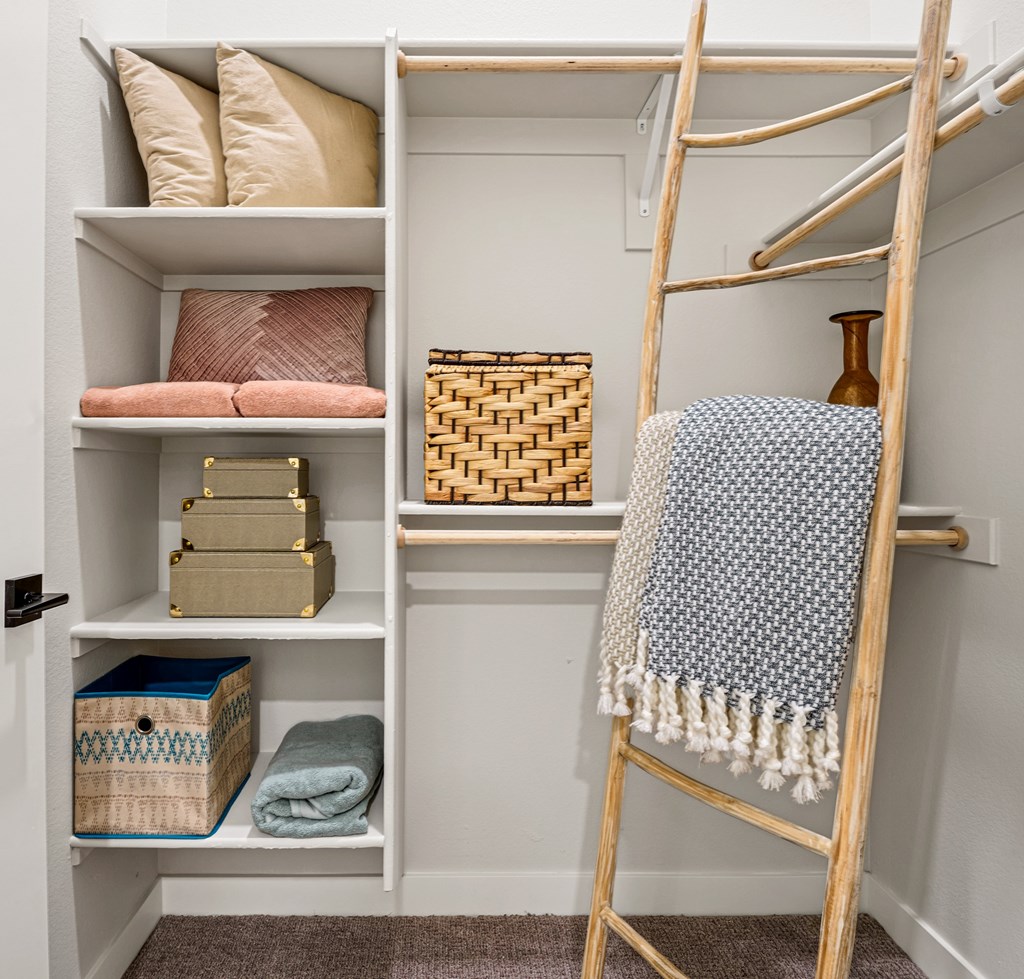 A ladder is leaning against a wall with a blanket hanging on it.