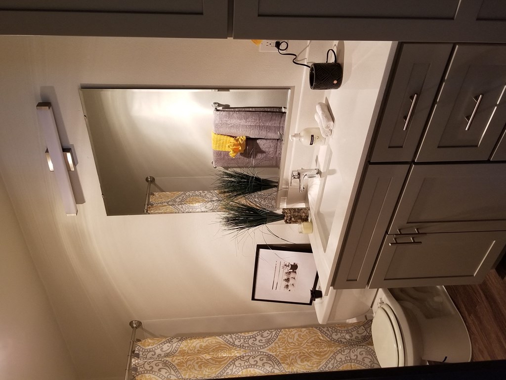 a small bathroom with a toilet and a mirror