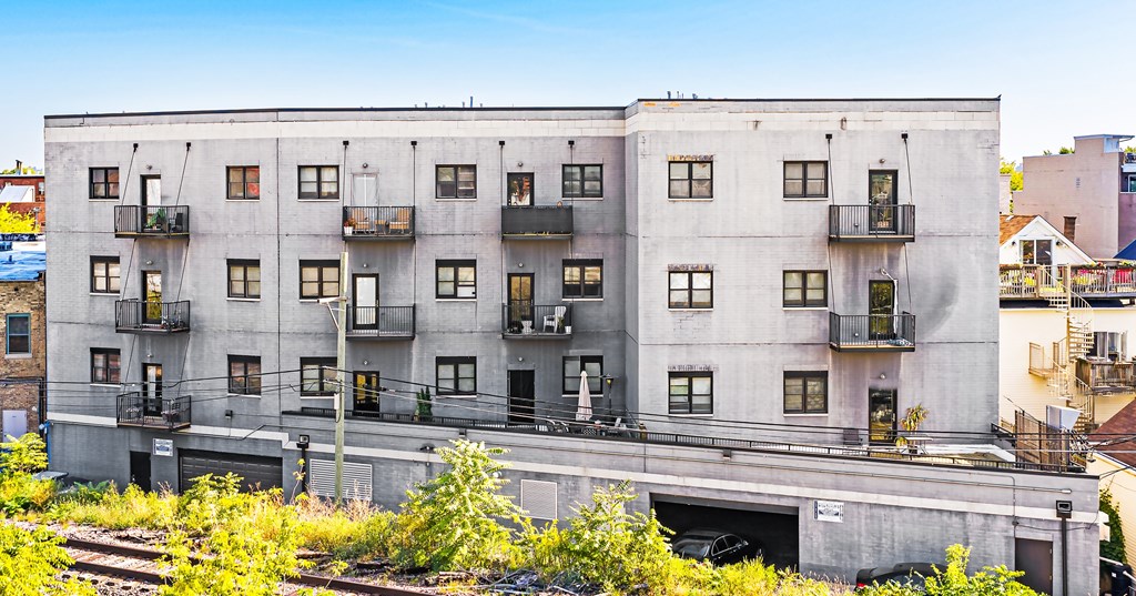 A large concrete building with many windows and balconies.
