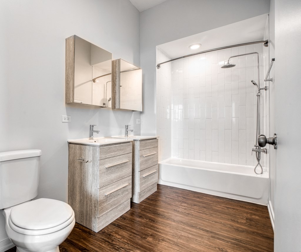 a bathroom with a toilet and a shower and a sink