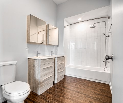 a bathroom with a toilet and a shower and a sink