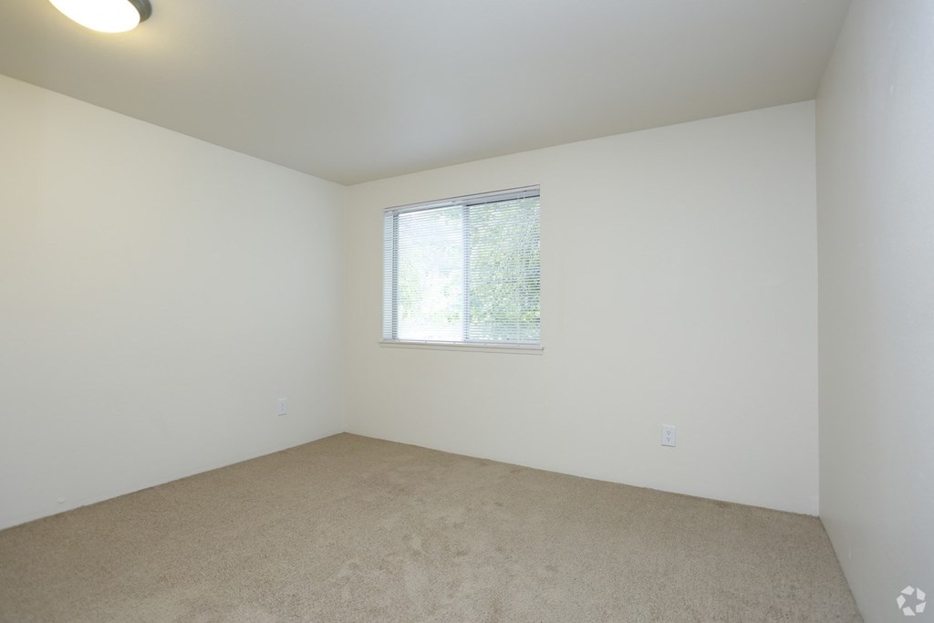 a room with white walls and a window