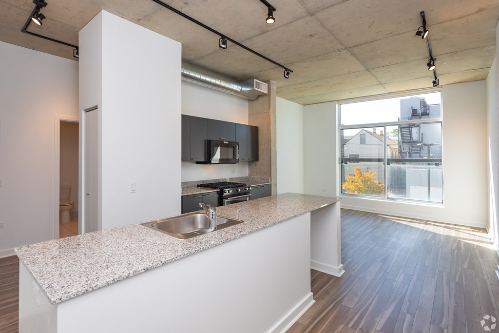 an open kitchen and living room with a large window