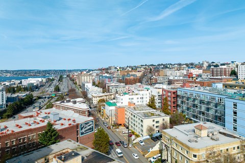 an aerial view of the city of seattle with a blue sky and a body of water