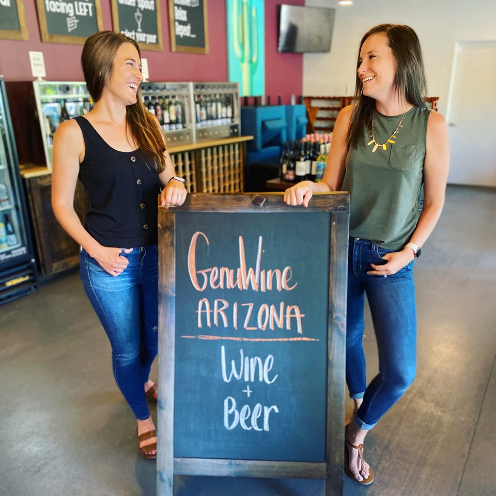 Ladies Standing By GenuWine Sign