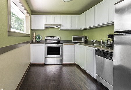 a kitchen with stainless steel appliances and white cabinets