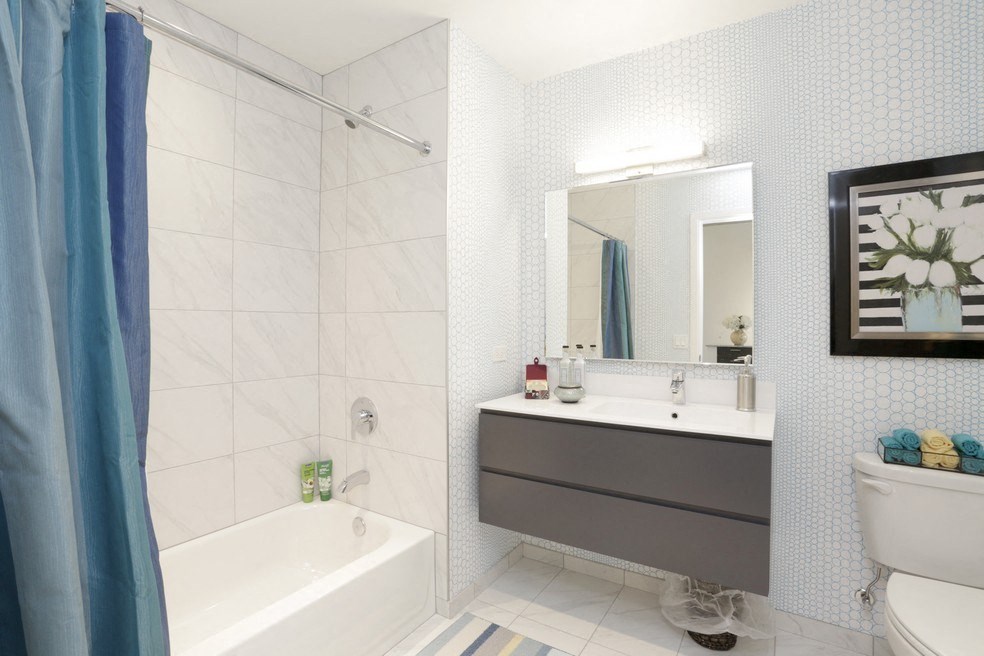 a bathroom with a tub and a sink and a mirror