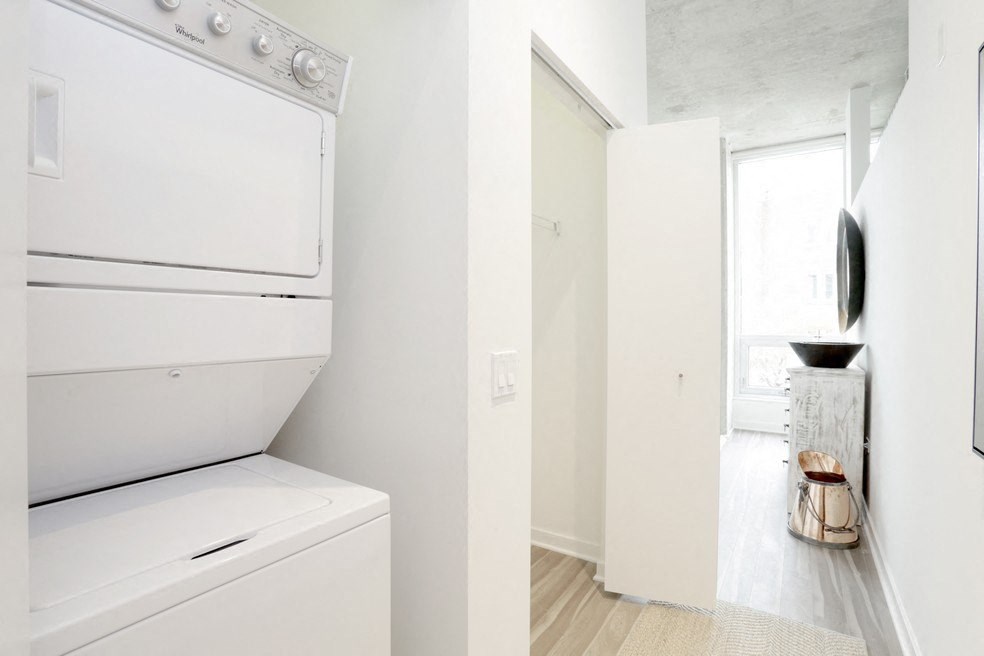 a white laundry room with a washer and dryer