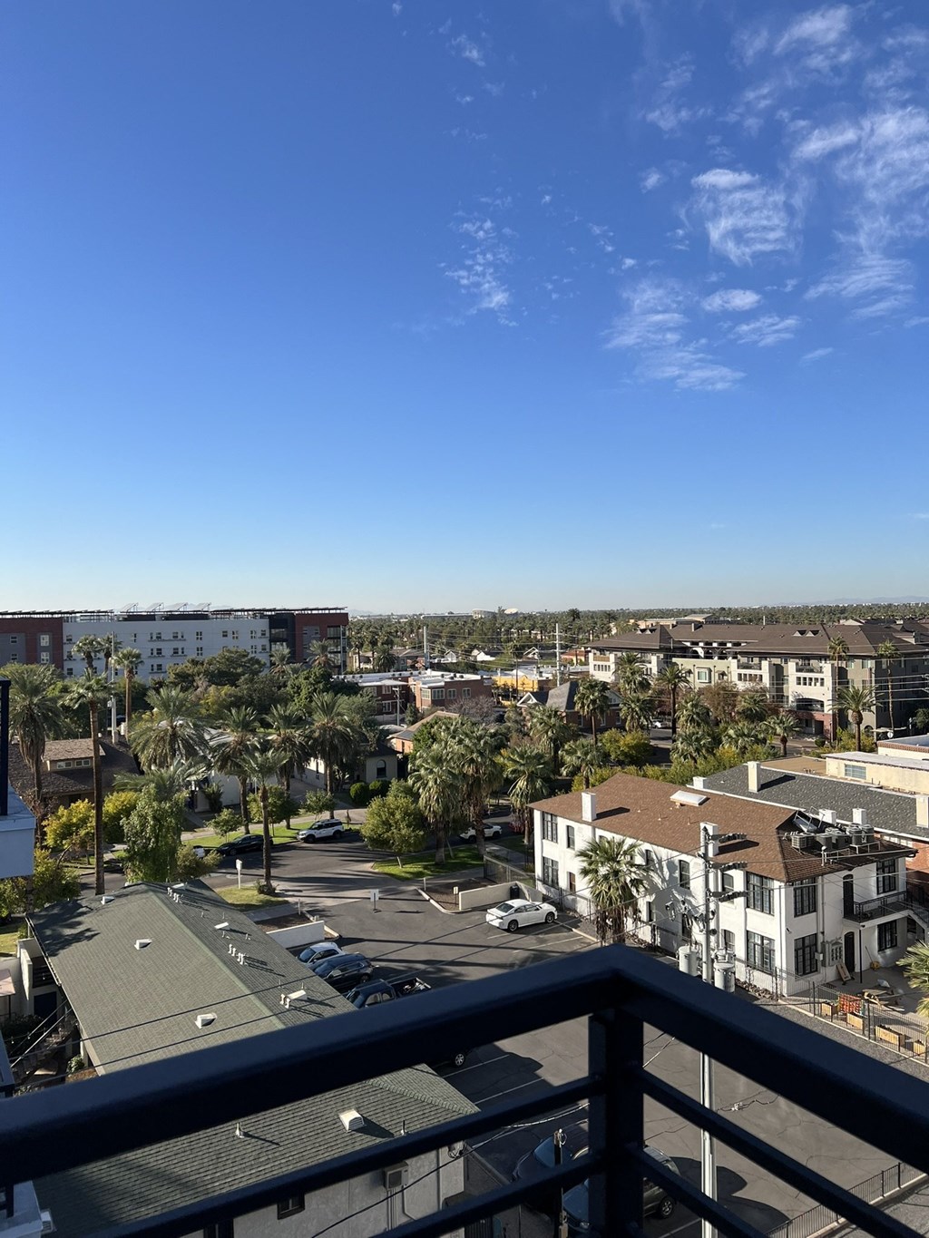 a view of the city from the balcony of a condo