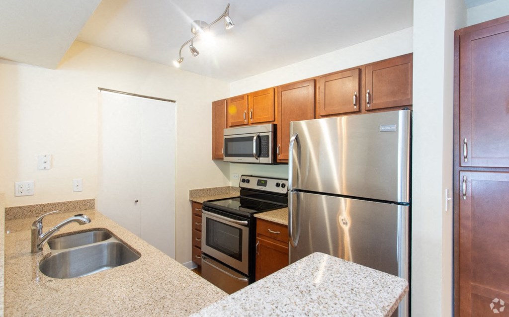 a kitchen with stainless steel appliances and granite counter tops