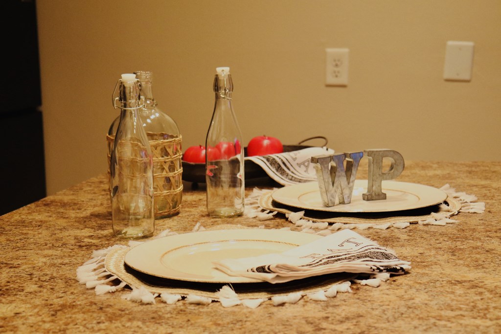 a table set with plates and a bottle of wine on it