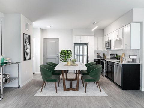 an open kitchen and dining room with a table and chairs