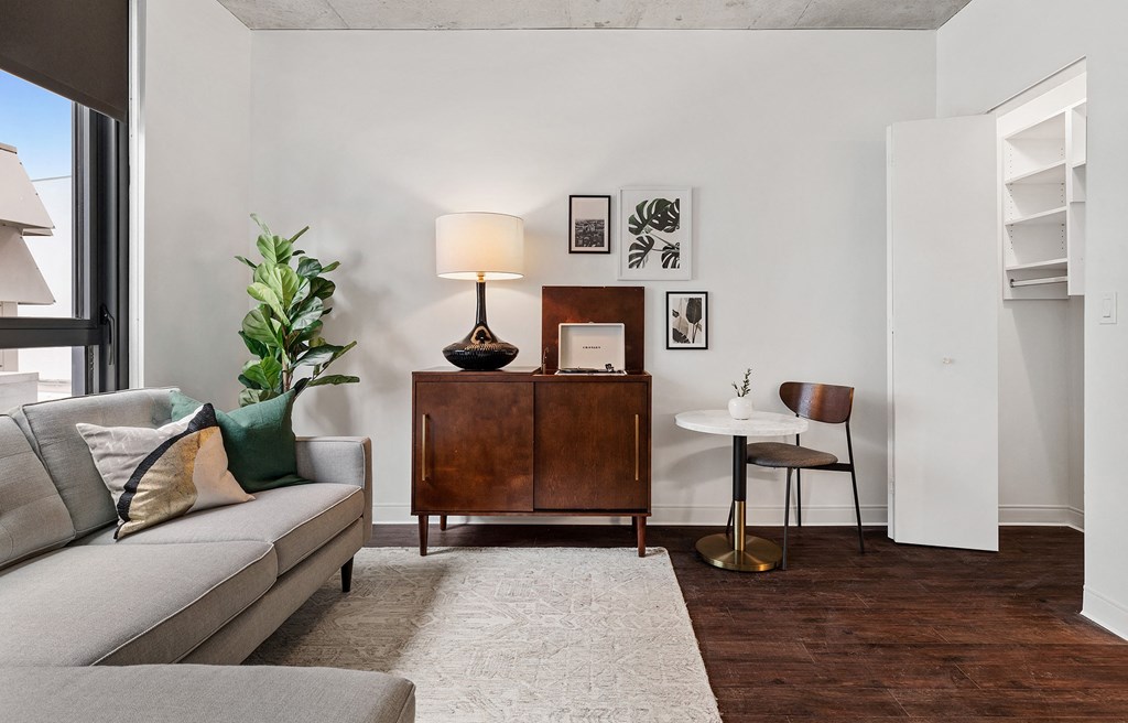 a living room with a couch and a table and a dresser