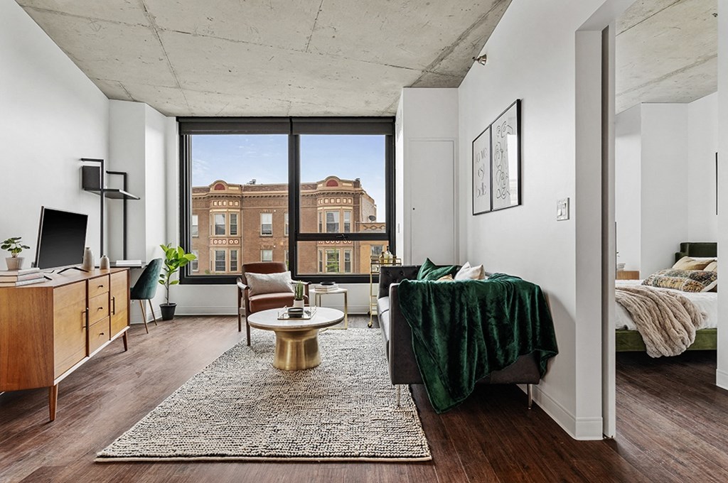 a living room with a couch and a table and a large window