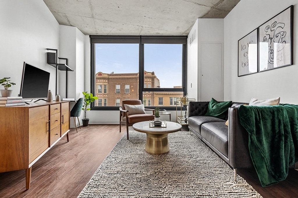 a living room with a large window and a couch