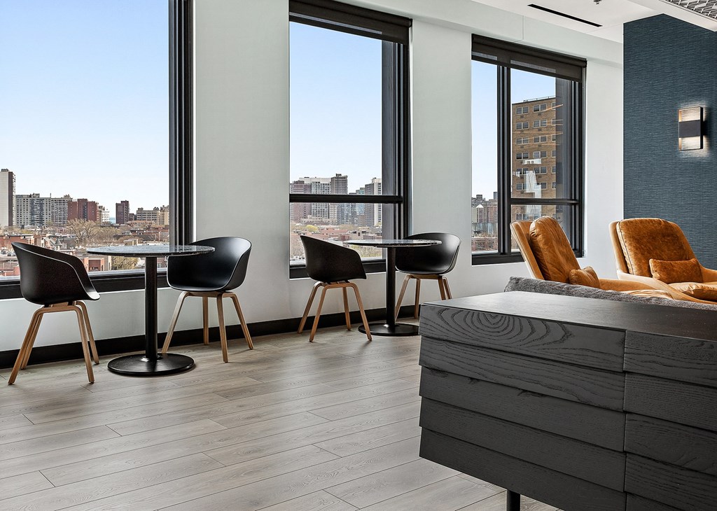 a living room with a table and chairs and a large window