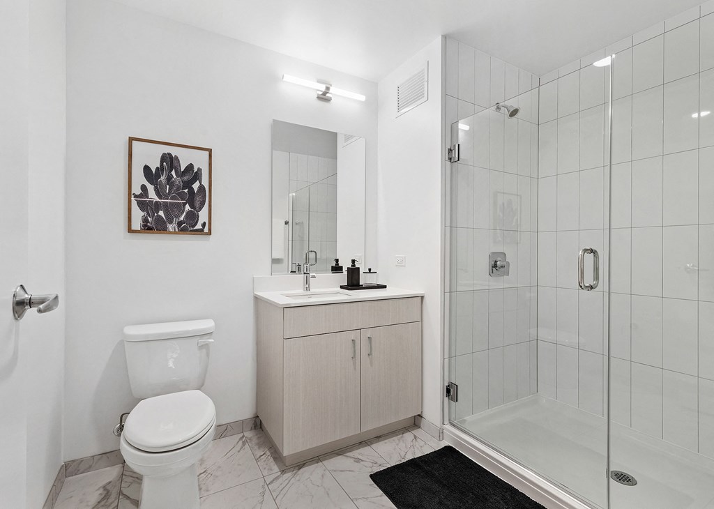 a bathroom with a shower toilet and sink