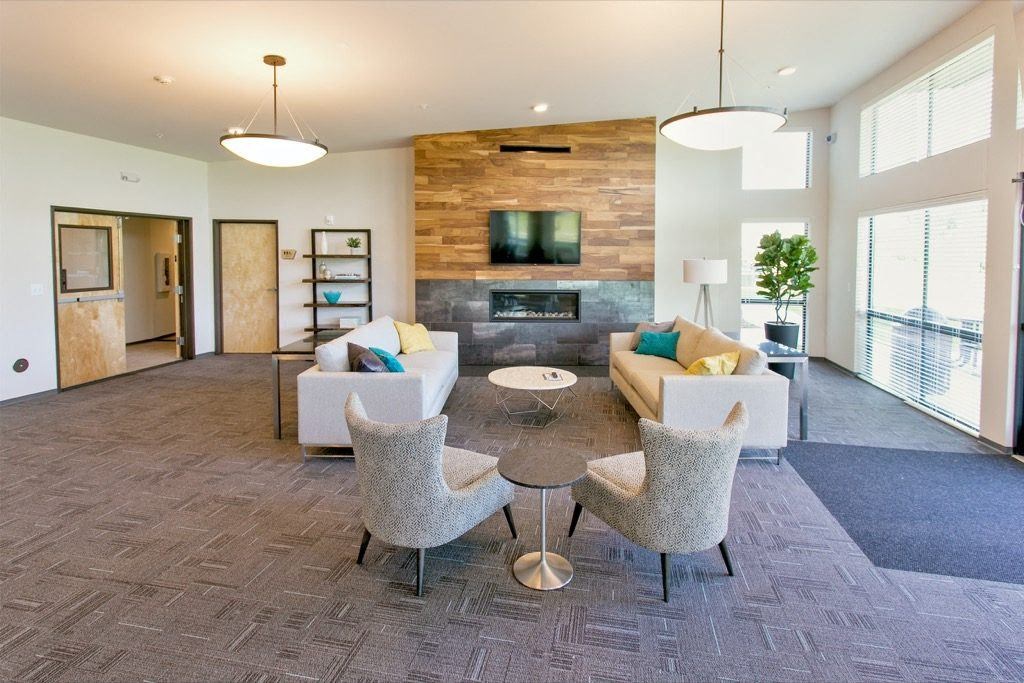 a living room with couches and chairs and a fireplace