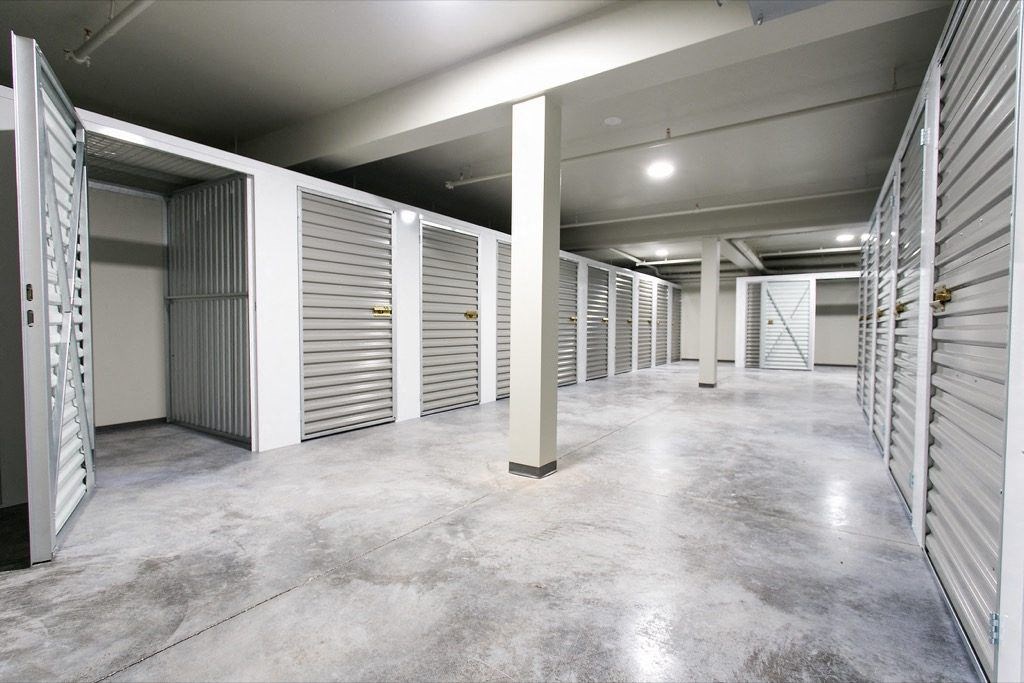 the interior of an empty storage room with doors