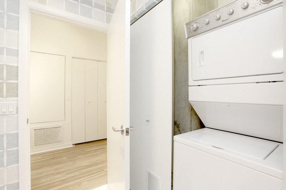 a white washer and dryer in a room with a door