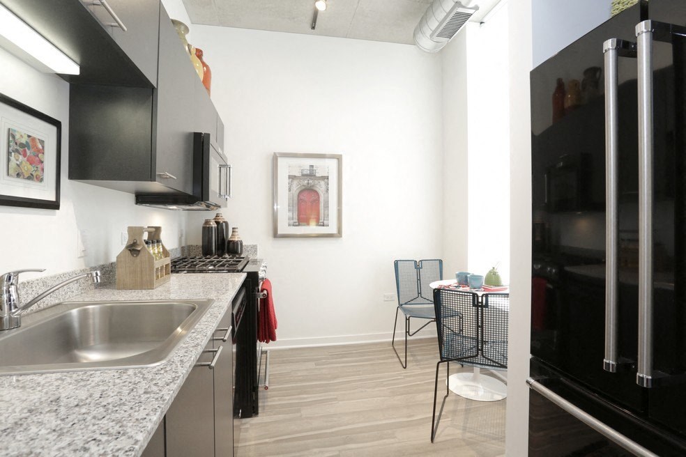 a kitchen and living room with a sink and a table