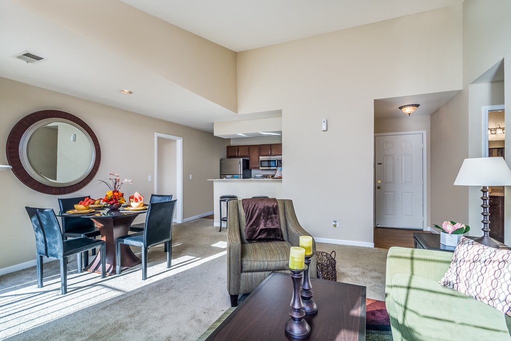 a living room and dining room with a table and chairs and a kitchen