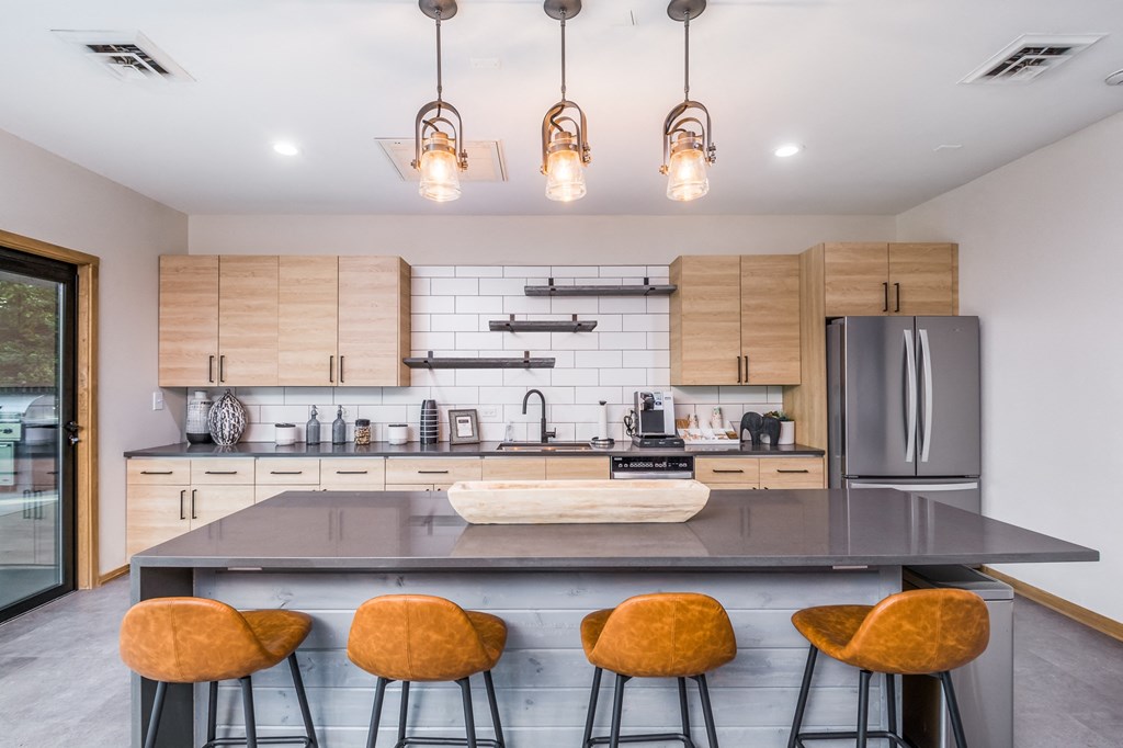 a kitchen with a large island and bar stools