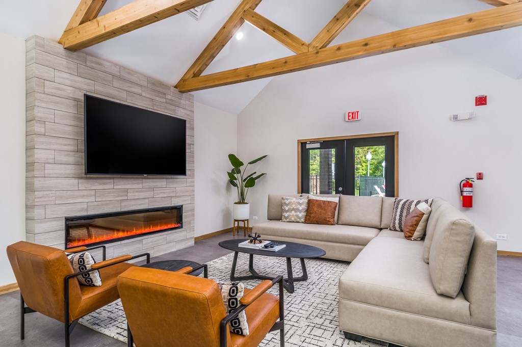a living room with a couch and a fireplace and a tv