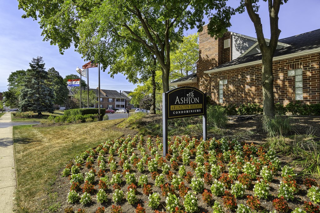 exterior view sign in front of a garden and brick building