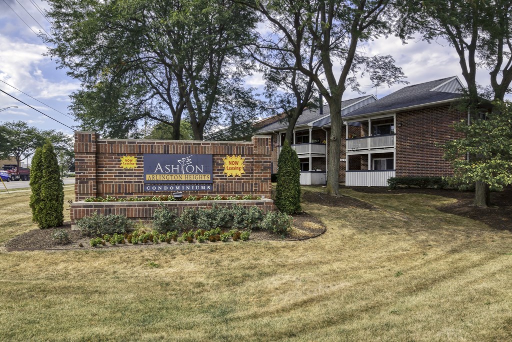 the exterior of the ashton apartment building with a sign