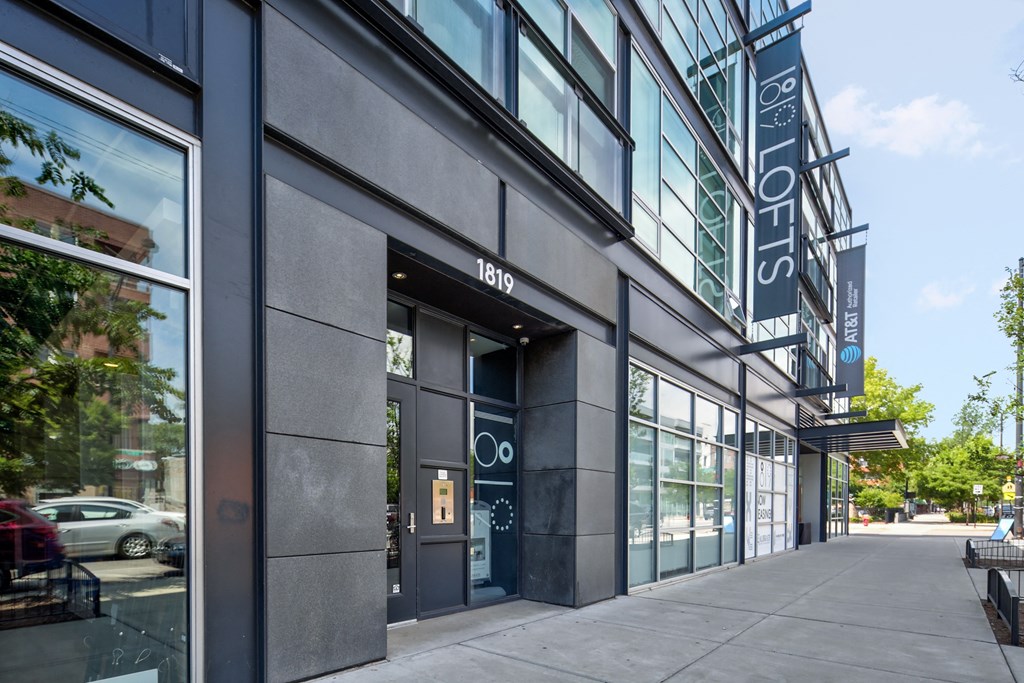 the side of a building with a sidewalk in front of it