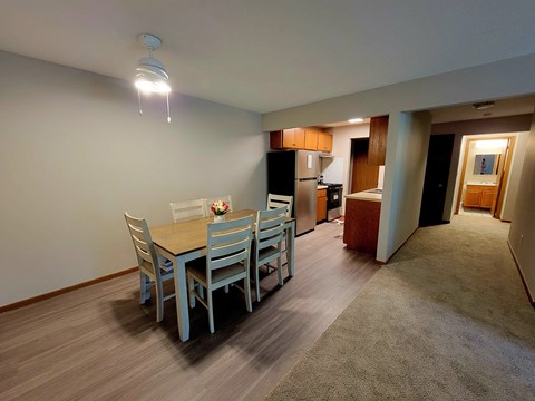 a dining room with a table and chairs and a kitchen