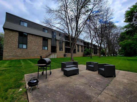 our apartments have a patio with seating and a grill