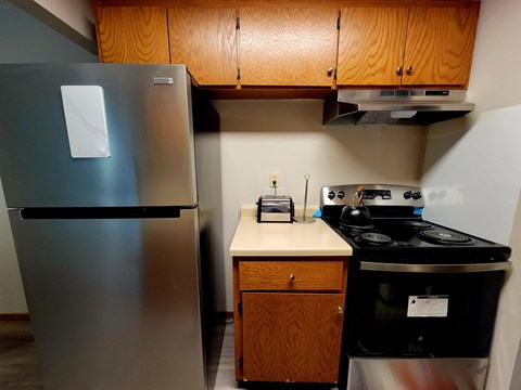 a kitchen with a stove and a refrigerator