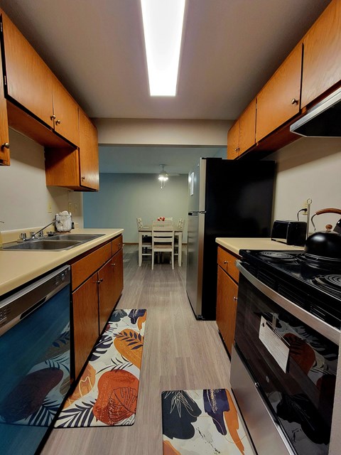 a kitchen with a stove and a sink and a table