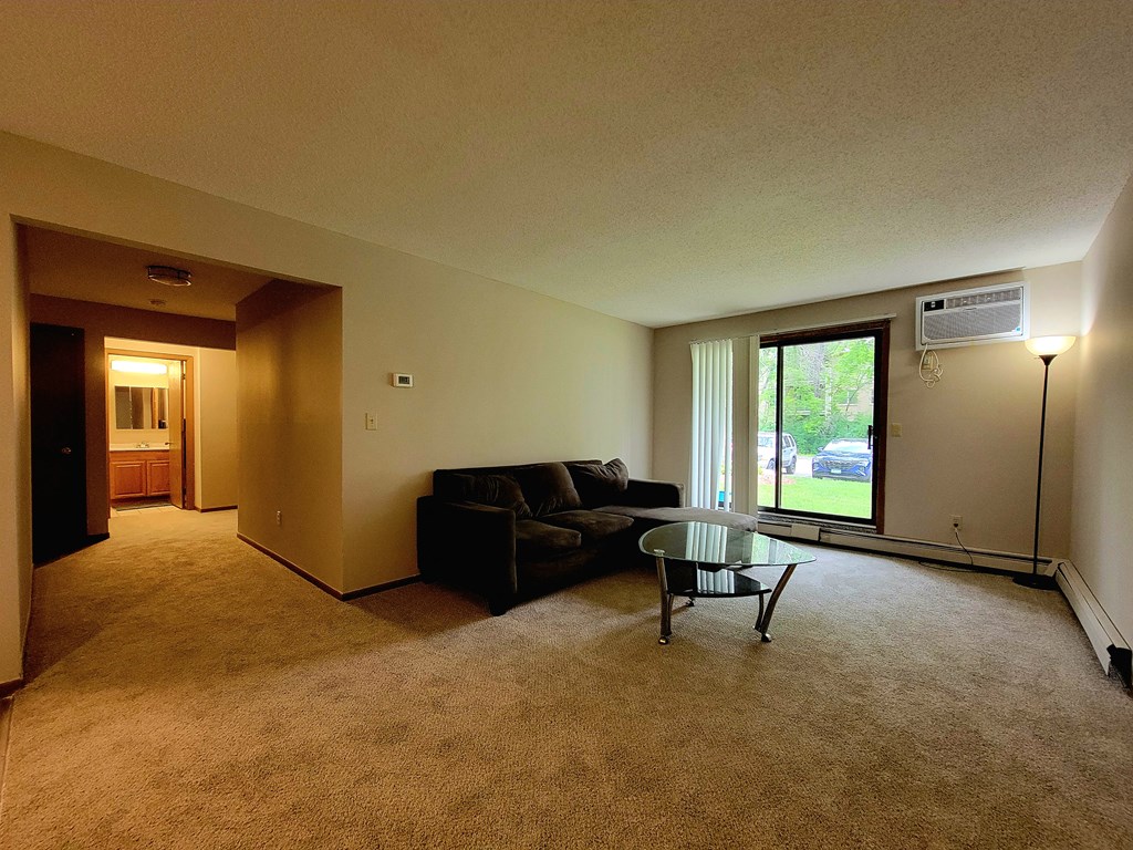 a living room with a couch and a glass coffee table