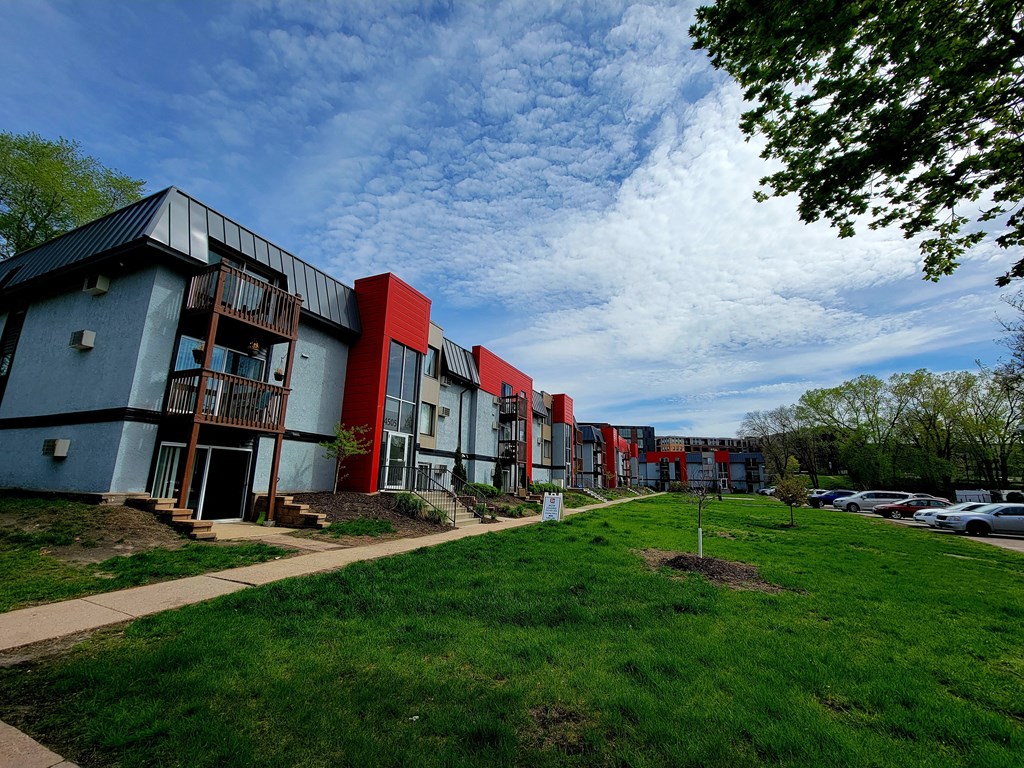 a row of houses in a park with green grass