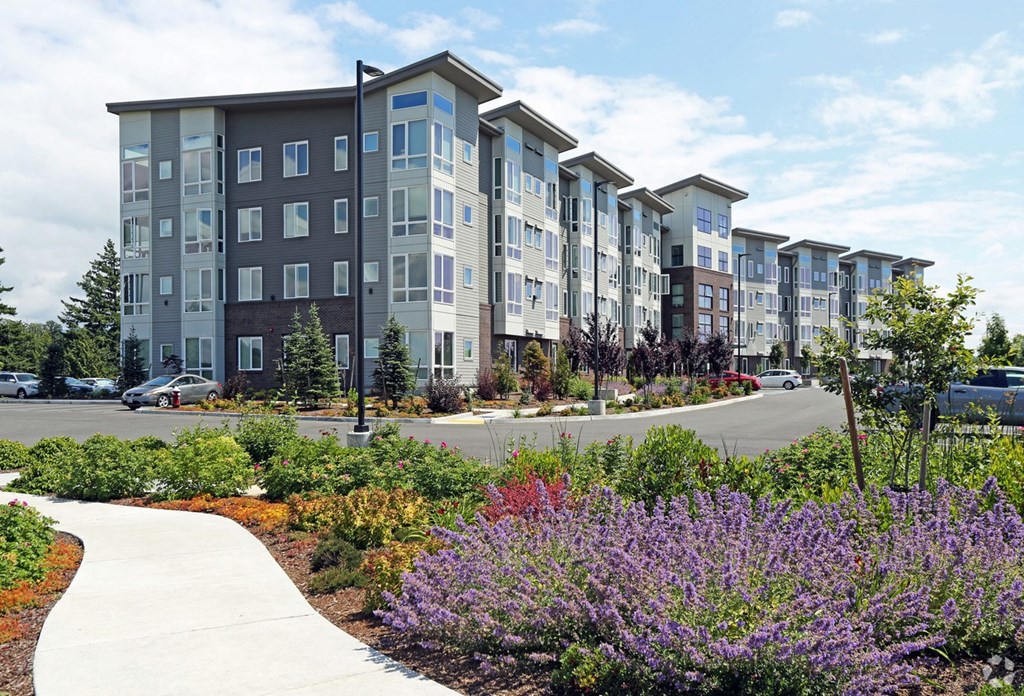 an exterior view of an apartment building on a city street