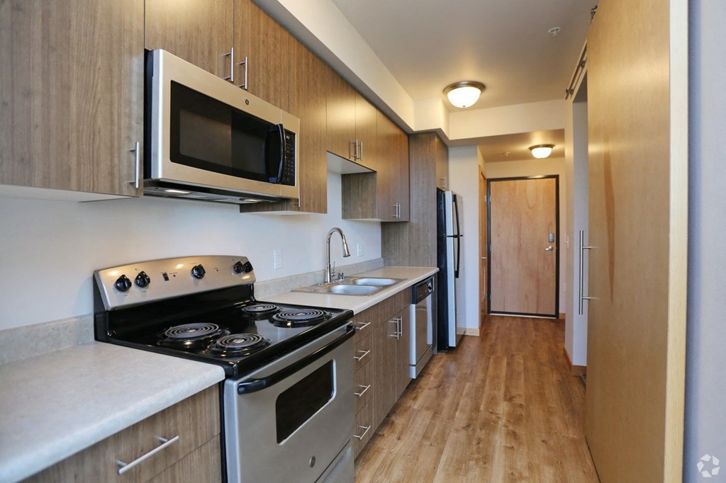 a kitchen with stainless steel appliances and a microwave