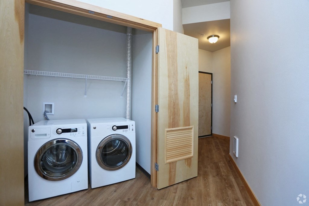 a washer and dryer in a laundry room with a door