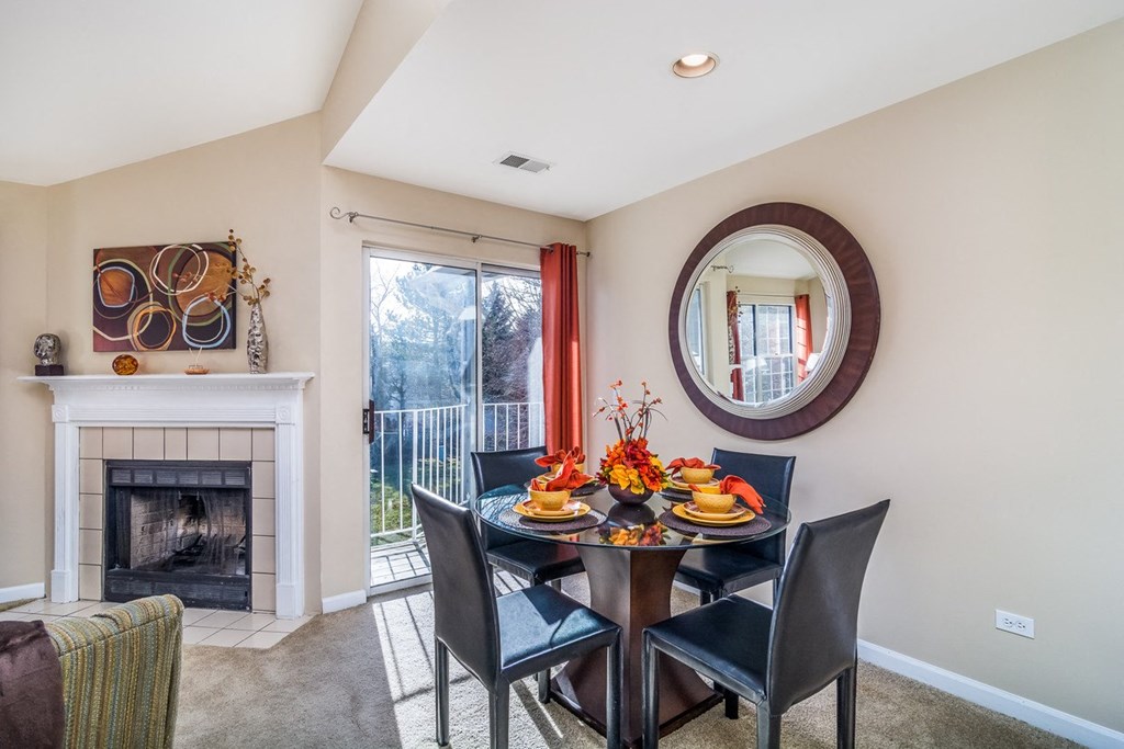 a dining room with a table and chairs and a fireplace