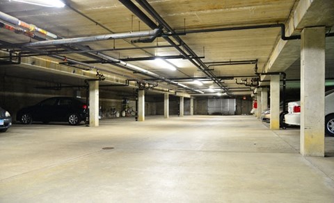 an empty parking garage with cars in it