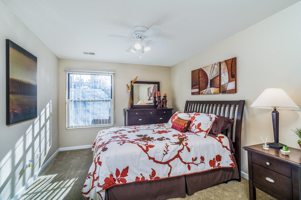 a bedroom with a bed and a ceiling fan
