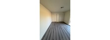 A room with a wooden floor and white walls.