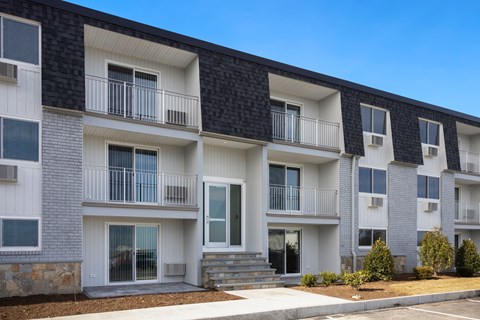 Building with balconies and a sidewalk at 151 Ocean Road LLC, Rhode , 02882