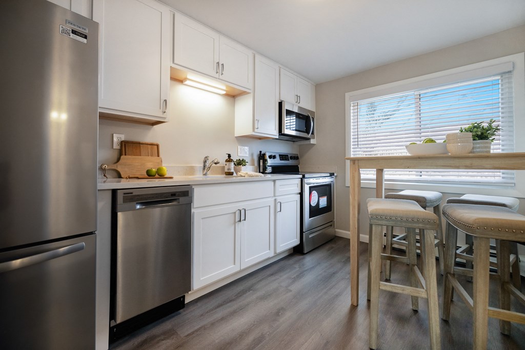Large white kitchen with stainless steel appliances and wide window at 151 Ocean Road LLC, Rhode