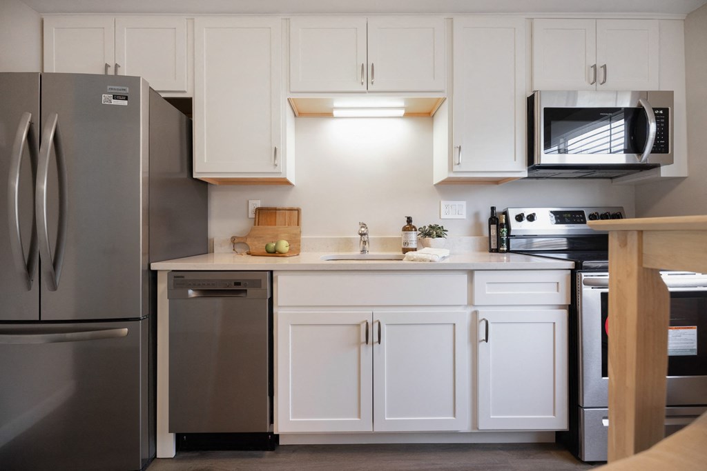 Modern Kitchen With White Cabinet and a marble counter top at 151 Ocean Road LLC, Rhode , 02882