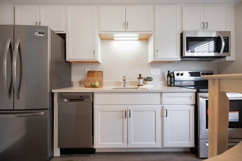 Modern Kitchen With White Cabinet and a marble counter top at 151 Ocean Road LLC, Rhode , 02882